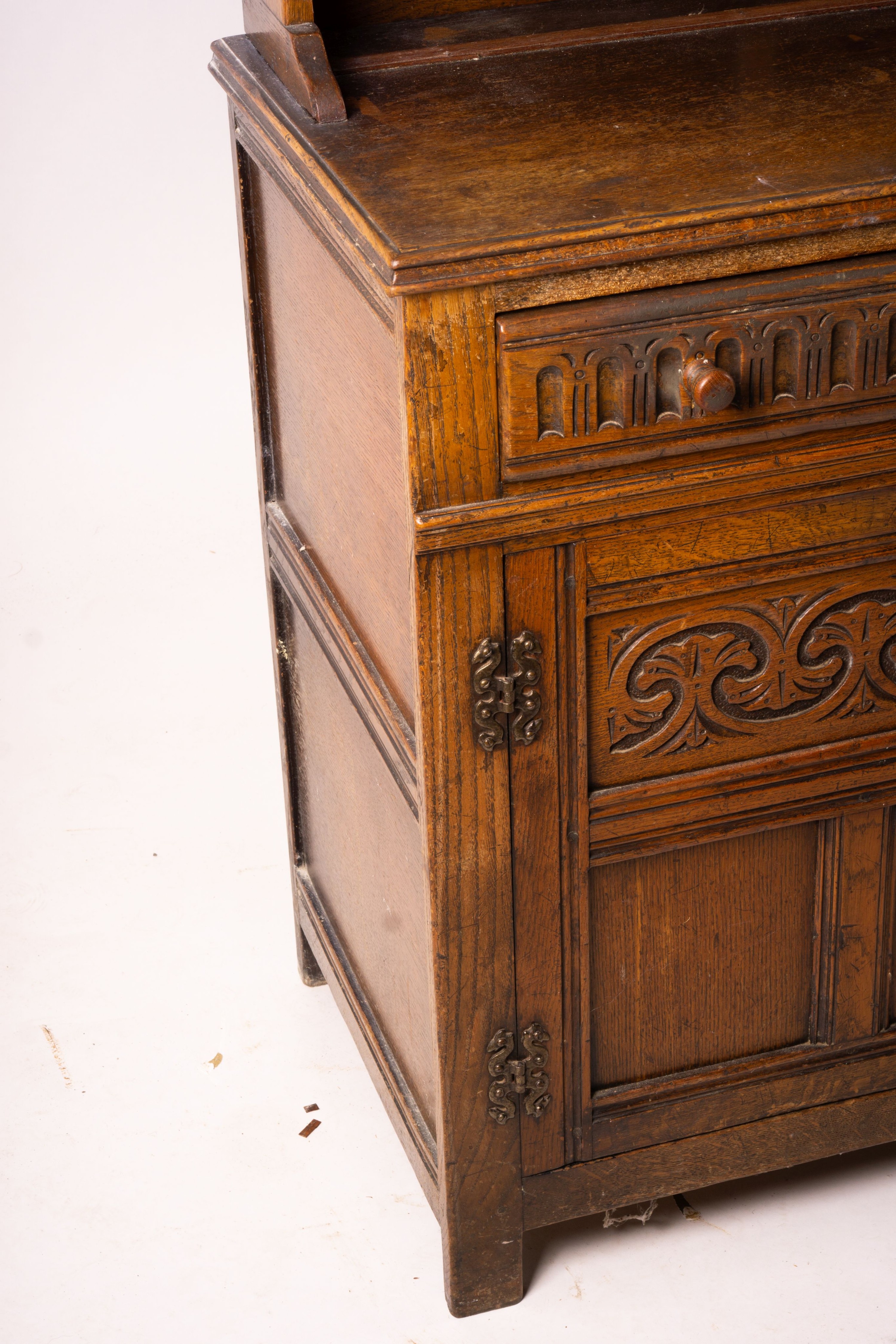 An 18th century style carved oak dresser, width 124cm, depth 46cm, height 175cm